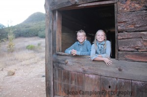 Kids smile in cabin window
